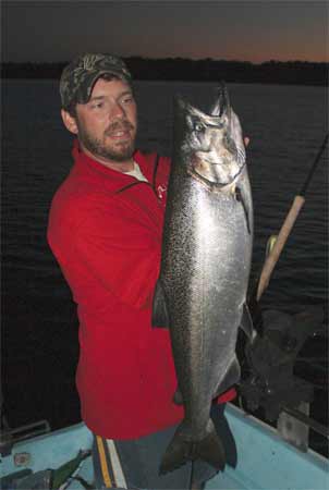 Josh Choronzey hoists a large Chinook taken in Owen Sound Bay.  The fish was caught on a Spin Doctor and Anchovy combo in 90 feet of water.
