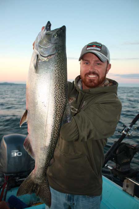 Dan Gravel of Owen Sound hoists a 12 lb Chinook caught on Sunday in Owen Sound Bay.  Gravel's salmon just missed the top ten daily leader board.  The fish was caught on a rotating flasher and fly combo trolled in 120 feet of water.