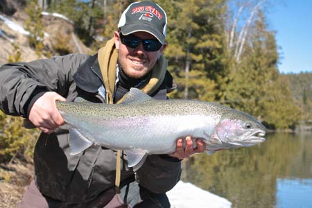 London resident Tom Hamilton traveled to a Bruce County river to sample some spring steelhead fishing this week.  This trout was caught and released in a recently melted section of river.